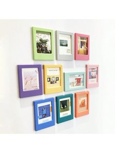 multi - colored frames are arranged on the wall to create a colorful art piece that looks like it's floating