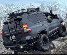 an suv parked on top of a rocky hill