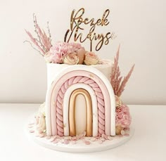 a pink and white cake decorated with flowers