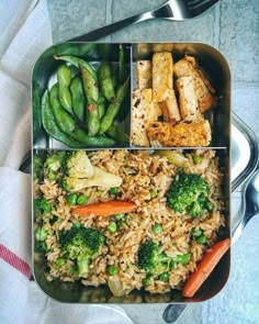 two trays filled with rice, vegetables and tofu