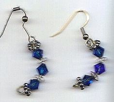 deep blue and clear crystals on goldtone ear wires, curved shape ﻿Please allow 1 extra week for custom making.approx 1.5" Blue Metal Crystal Earrings With Ear Wire, Blue Crystal Earrings With Metal Ear Wire, Blue Wire Wrapped Drop Earrings, Blue Wire Wrapped Dangle Crystal Earrings, Blue Crystal Pierced Earrings, Nickel Free Blue Crystal Earrings, Nickel-free Blue Crystal Earrings, Beaded Jewelry Earrings, Diy Jewelry Unique