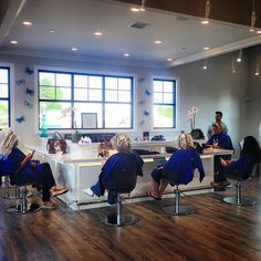 a group of people sitting in chairs around a counter