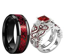 two wedding bands with red and black designs on them, one has a diamond in the center