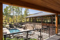 an outdoor swimming pool and hot tub in the middle of a wooded area with trees