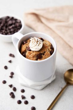 two mugs filled with chocolate chip cookies and whipped cream