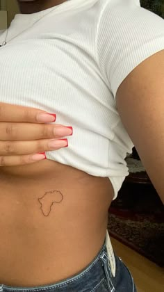 a woman's stomach with a small tattoo on it