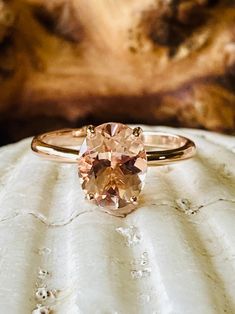 This classic 4 prong setting contains a beautiful 2.5ct. natural oval cut morganite. Morganite is a beautiful peachy pink color. The oval stone measures approximately 10x8mm. The ring is available in 14k white, yellow, or rose gold. This ring makes a great promise or engagement ring. Please send me a message if you need a size not listed. * This ring can be customized with any color center stone. All items are handmade by me in my shop in Manalapan, NJ. Please message me with any questions. Ship Peach Moissanite Engagement Ring, Rose Gold Oval Morganite Topaz Ring, Classic Oval Morganite Ring, Oval Morganite Rings With Accent Stones, Solitaire Morganite Oval Ring, Oval Morganite Solitaire Ring, Oval Solitaire Topaz Ring In Rose Gold, Oval Morganite Rose Gold Wedding Ring, Oval Rose Gold Morganite Wedding Ring