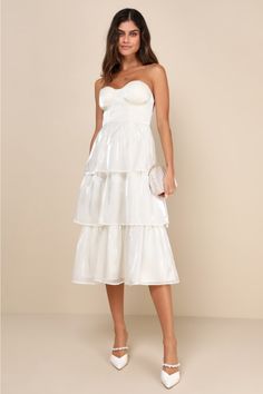 You'll have everyone wrapped around your finger in the Lulus Com-pleat-ly Charming Ivory Organza Tiered Strapless Midi Dress! Airy woven organza, with a stunning sheen throughout, shapes a pleated, strapless bustier-style bodice with hidden no-slip strips, lightly padded cups, and supportive underwire and side boning. Fitted waist tops a tiered skirt that ends at a midi hem. Hidden zipper/clasp at back. Fit: This garment fits true to size. Length: Mid-calf length. Size medium measures 40" from t White Organza Midi Dress For Evening, Formal White Organza Midi Dress, Chic White Organza Midi Dress, Elegant Tiered Strapless Dress For Party, Spring Wedding Strapless Tiered Dress, White Strapless Summer Dress With Pleated Bodice, White Organza Midi Dress For Wedding, Strapless Midi Dress For Wedding Guest, Strapless White Organza Dress