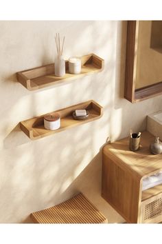 a bathroom with wooden shelves on the wall