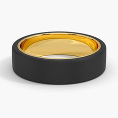 a black and gold wedding ring on a white background