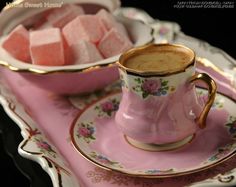 pink sugar cubes are in a bowl and on a saucer next to a plate