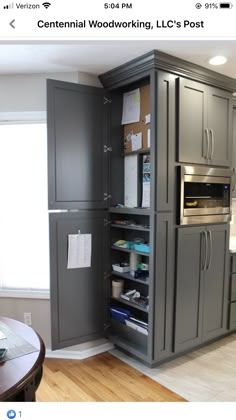 a kitchen with gray cabinets and wood flooring in the center, along with an open pantry