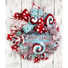 a red and white wreath with candy canes on it