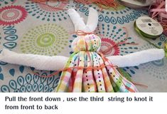 an image of a doll made out of fabric and thread on top of a table