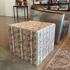 a box made out of money sitting on the ground