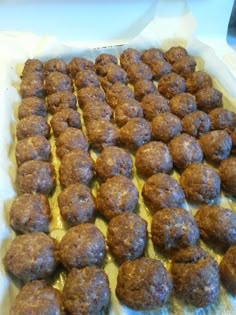 there are many balls of food on the baking sheet ready to be baked in the oven