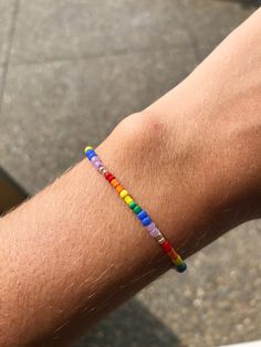 Dainty, stretchy rainbow seed bead bracelet. Sizing tip: my wrist (shown in the picture) fits best with a 6.5 inch bracelet. Lgbtq Bracelet, Braided Bracelet Diy, Pride Bracelet, Seed Bead Bracelet, Rainbow Bracelet, Bracelet Dainty, Rainbow Beads, Braided Bracelet, Bracelet Diy