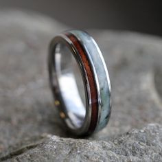 a wedding band with two different colored wood inlays