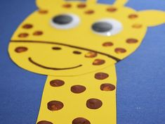 a paper cut out of a giraffe's head with eyes and nose