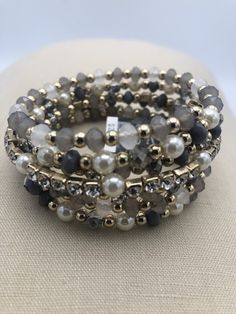 three bracelets with pearls and black beads