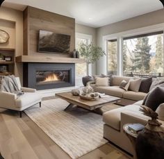 a living room filled with furniture and a fire place in the middle of it's wall