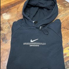 Black Women’s Nike Hoodie. Drawcord Hoodie With Two Front Pockets. Silver Swoosh With White Nike Lettering On The Front. Nike Hooded Hoodie For Streetwear, Nike Hooded Sweatshirt For Streetwear, Nike Hoodie With Letter Print, Nike Fleece Hoodie With Letter Print, Black Nike Hooded Hoodie, Nike Black Hooded Hoodie, Black Nike Hoodie With Adjustable Hood, Nike Urban Black Hoodie, Nike Black Sweatshirt With Drawstring Hood