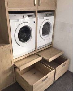 a washer and dryer sitting in a room next to each other with drawers