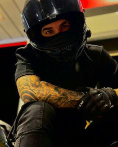 a man wearing a motorcycle helmet and gloves