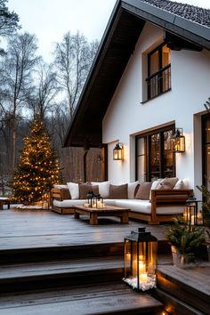 an outdoor deck with candles and christmas tree