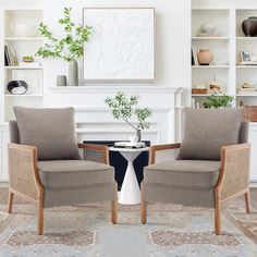 two chairs sitting next to each other on top of a rug in front of a fireplace