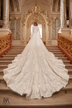 a woman in a wedding dress standing on some stairs