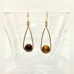 Imagine Wearing These Exquisite Handmade Tiger's Eye Wire-Wrapped Dangle Earrings, Each Bead Lovingly Encased In Shimmering Gold Tone Wire That Dances With Every Movement. The 9mm Genuine Tiger's Eye Beads, With Their Mesmerizing Golden-Brown Hues, Exude A Sense Of Warmth And Depth. The Handcrafted French Hook Ear Wires Ensure A Secure And Comfortable Fit, Allowing You To Wear These Earrings With Confidence All Day Long. Their Minimalist Design Adds A Touch Of Modern Elegance To Any Outfit, Whet Simple Wire Wrap Earrings, Fall Wire Wrapped Jewelry, Wire Wrapped Bead Earrings, Diy Wire Wrapped Earrings, Brass Wire Jewelry, Gold Hand Wrapped Teardrop Earrings, Adjustable Teardrop Wrap Earrings As Gift, Adjustable Teardrop Wrap Earrings For Gift, Teardrop Earrings Gift