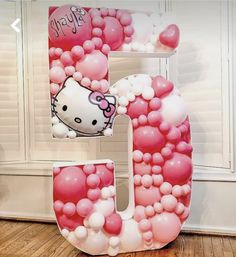 the letter b is made up of balloons and helium balls, with a hello kitty face on it