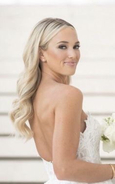 a woman in a wedding dress holding a bouquet