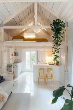 the interior of a tiny house with white walls and wood flooring is decorated in natural materials