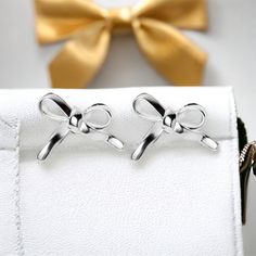 Introducing our Vermeil 18k gold plated 925 sterling silver elegant bow earrings. Crafted with meticulous attention to detail, these earrings features exquisite hand crafted enamel plated mushrooms. While corky by design the hand made earrings can also add a touch of sophistication to any outfit.    Made from high-quality 925 sterling silver, this piece is then expertly plated with a layer of 18k gold, creating a luxurious and durable finish.    The contemporary design of these earrings makes it a versatile accessory that can be worn for both casual and formal occasions.   With its sleek and modern aesthetic, these earrings are sure to become a timeless addition to your jewelry collection. 16 mm long, 11.5 mm deep, and 6 mm wide these make a very danity piece of jewelry. Care Tips for your Sterling Silver White Gold Earrings With Bow, White Gold Bow Earrings For Gift, White Gold Sterling Silver Earrings With Bow, Dainty Silver Bow Earrings, Silver Bow Earrings For Anniversary, Elegant Butterfly Knot Earrings As Gift, Elegant Butterfly Knot Earrings For Gift, Classic Bow Earrings For Anniversary, Classic Earrings Perfect For Gifts