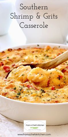 southern shrimp and grits casserole in a white dish with a wooden spoon