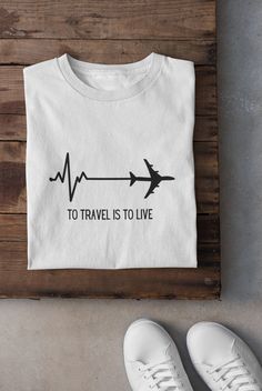 "ABOUT OUR:  TO TRAVEL IS TO LIVE tee 👉 Unisex T-shirt - Light fabric (4.2 oz/yd² (142 g/m²) - Retail fit - Tear away label - Runs true to size - 100% Airlume combed and ringspun cotton  - Soft cotton and quality print make users fall in love with it over and over again.  - These t-shirts have-ribbed knit collars to bolster shaping. - Printed and shipped from the USA CARE INSTRUCTIONS - Wash inside out with like colors. - Tumble dry or hang to dry. - Try not to iron directly over the design. Iron if necessary!  HOW TO ORDER  1) Please, check and review all photos  2) Choose your sweatshirt or t-shirt style, color, and size 3) Click add to cart. You can go back and follow the same steps to add more items to your cart 4) Click \"Proceed to check out\"  5) Add your shipping address and choos Black Text Print T-shirt For Vacation, White Graphic Print T-shirt For Travel, Vacation Text Print Relaxed Fit T-shirt, Black T-shirt With Screen Print For Adventure, Graphic Print Short Sleeve T-shirt For Travel, To Travel Is To Live, Camping Tshirt, Motivation Shirt, Travel Tshirt