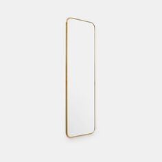 a rectangular mirror with a gold frame on the front and bottom, against a white background