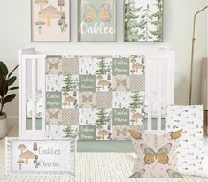 a baby crib bedding set with three pillows and two wall hangings on the wall