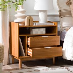 a nightstand with two drawers and a lamp