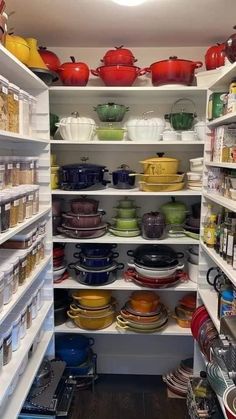 an open pantry filled with lots of dishes and pans