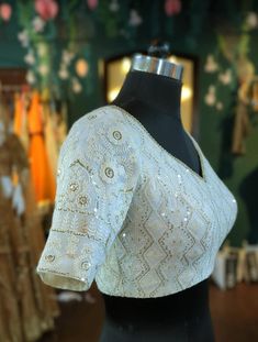 Ivory chikenkari blouse with sequin work.  Blouse is custom made to your measurements.  I'll send a measurement form once you order .  Please convo me if you're have any specific requirements.  The blouse is fully lined is cotton. Hooks at the back Luxury Embellished Chinon Blouse Piece, White Embroidered Top For Reception, Traditional White Tops With Zari Work, Traditional White Top With Zari Work, White Resham Embroidery Top For Wedding, White Resham Embroidery Top For Reception, White Blouse With Resham Embroidery For Festive Occasion, White Tops With Resham Embroidery For Reception, Fitted Bollywood Style Embroidered Off White Fabric