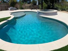 a swimming pool with grass around it