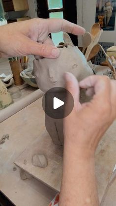 a person is working with clay on a table