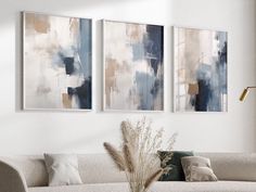 a living room with two paintings on the wall