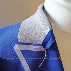 a close up of a blue shirt and tie on a mannequin's head