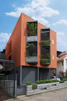 an apartment building with plants growing on the balconies