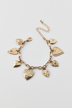 Vintage-inspired charm bracelet trimmed with a mix of heart-shaped charms. Choose from a silver or gold bracelet. Features Kyla heart charm bracelet Vintage-style charm bracelet Adjustable length Content + Care Mixed metal, glass Avoid contact with water Imported Size Dimensions: 7.5" l + extender | Kyla Heart Charm Bracelet in Gold, Women's at Urban Outfitters Cheap Metal Heart Charm Bracelet, Gold Metal Charm Bracelet With Heart Beads, Gold Heart Charm Bracelet In Metal, Gold-tone Metal Jewelry With Heart Charm, Affordable Gold-tone Metal Charm Bracelet, Men's Shoes Accessories, Vintage Charm Bracelet, Women Men Shoes, Mixed Metals