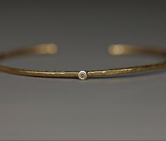 A handmade bangle made of 750 yellow gold with a brown diamond. Minimalist in design, it feels as light as a feather on the wrist. The hammered surface gives it a pretty structure, the fine matt finish creates a rich yellow gold tone. 750 white gold was chosen for the setting. The hoop is made to fit tightly. Its profile is rounded all around, which makes it very comfortable. A chic and elegant piece of jewelry that can also be beautifully combined with other bracelets. Dimensions: Width approx. Filigree Bangle, Hammered Bangles, Bangles Making, Handmade Bangles, Brown Diamond, Recycled Gold, Real Gold, Brown Gold, Jewelry Care